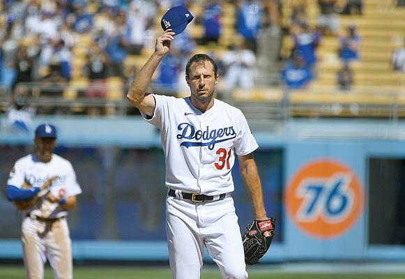 Max Scherzer tips his cap after he recorded his 3,000th career strikeout against Eric Hosmer of the Padres in the fifth inning of Sunday's game in Los Angeles.