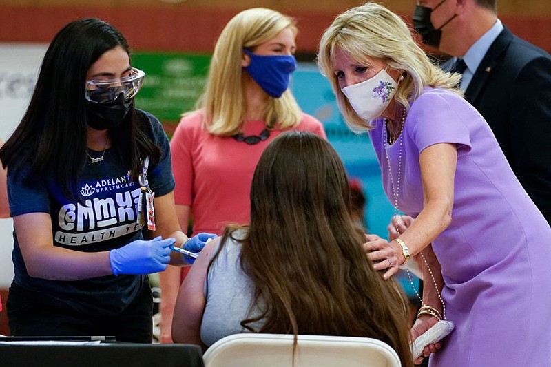 First lady Jill Biden comforts a person as they get a COVID-19 vaccination during a tour of the site at Isaac Middle School in Phoenix,  Arizona, June 30, 2021. (Carolyn Kaster/Pool/AFP via Getty Images/TNS)