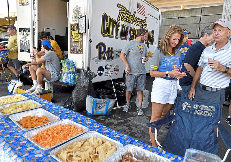 Friends at John Dusch's Mobile Tailgating Unit in the parking lot before Pitt takes on University of Massachusetts on Saturday, September 4, 2021, at Heinz Field in Pittsburgh. (Matt Freed/Pittsburgh Post-Gazette/TNS)