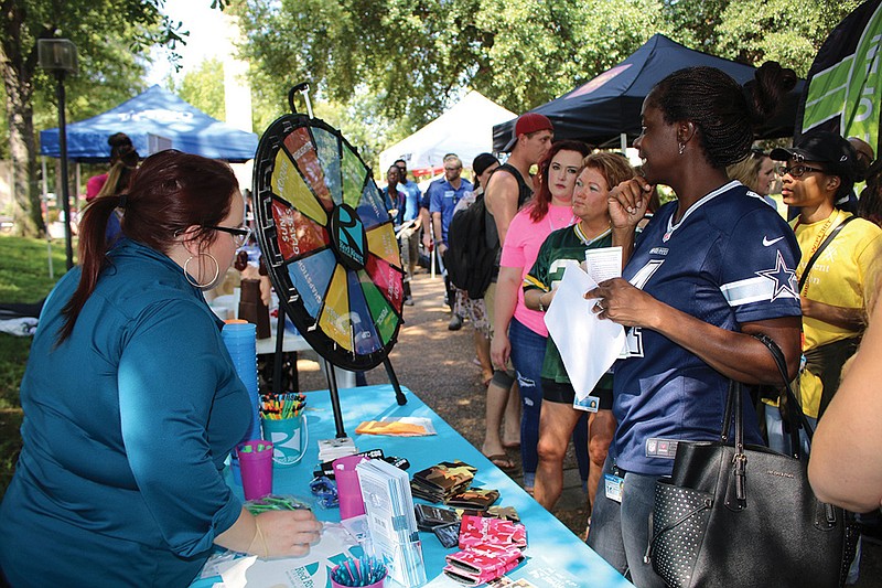 Texarkana College students interact with community vendor Red River Federal Credit Union at a past Fall Fest.