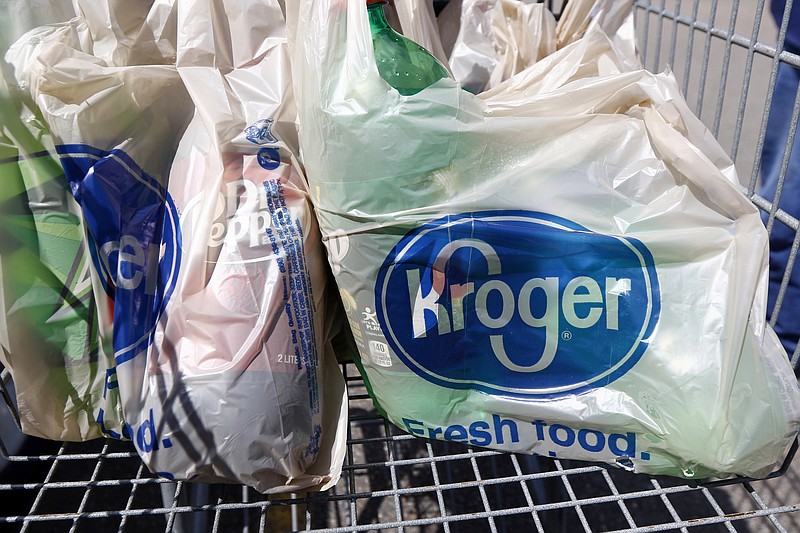 FILE - In this June 15, 2017, file photo, bagged purchases from the Kroger grocery store in Flowood, Miss., sit inside this shopping cart. Kroger is teaming up with Instacart on a new delivery service that can get grocery items to customers in as few as 30 minutes. The announcement comes at a time when many people are having groceries delivered for convenience and want their items to arrive quickly. Kroger Co. said Tuesday, Sept. 14, 2021 that the service, called Kroger Delivery Now, will offer 25,000 items and reach up to 50 million homes. (AP Photo/Rogelio V. Solis, File)