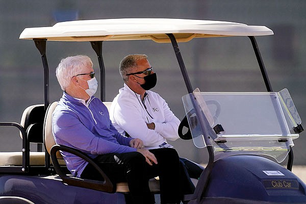 In this Feb. 24 file photo, Royals general manager Dayton Moore (right) and owner John Sherman watch a workout during spring training in Surprise, Ariz.
