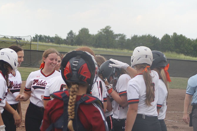 Senior Asya Nichols is mobbed by her New Bloomfield teammates Tuesday against Linn after hitting a home run to center in the third inning to make the score 2-1 New Bloomfield. The Wildcats would win 12-2 in five innings.