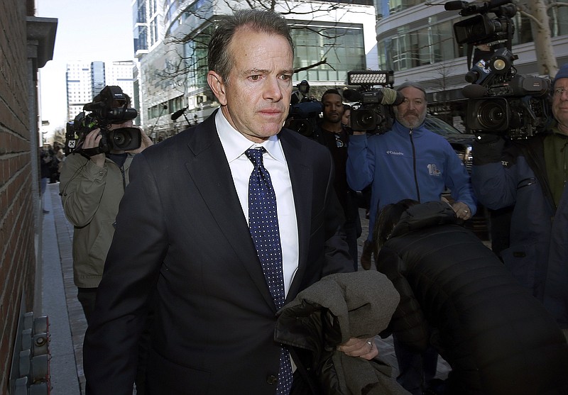 FILE - In this March 25, 2019 file photo, Gordon Ernst, former Georgetown tennis coach, departs federal court in Boston after facing charges in a nationwide college admissions bribery scandal. Ernst, accused of accepting more than $2 million in bribes to help kids get into the school, will plead guilty in the sweeping college admissions scandal, according to court documents filed Wednesday, Sept. 15, 2021. (AP Photo/Steven Senne, File)