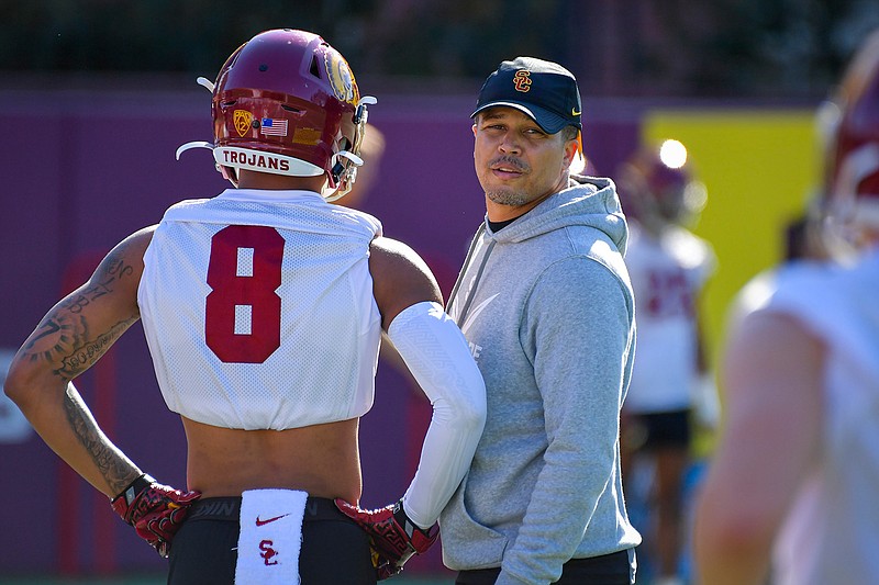 In this undated photo provided by the University of Southern California Athletics,  USC associate coach Donte Williams looks on during NCAA college football practice in Los Angeles. Williams, the Trojans' cornerbacks coach and associate head coach, is taking over for the rest of the season alongside offensive coordinator Graham Harrell and defensive coordinator Todd Orlando, after the school fired head coach Clay Helton on Monday, Sept. 13, 2021. (John McGillen/University of Southern California Athletics via AP)