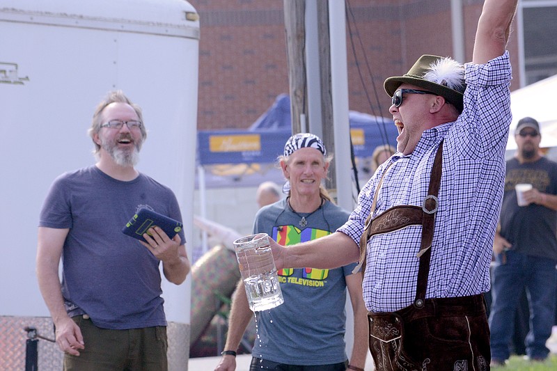 Sally Ince/ News Tribune
Doug Schneller celebrates Saturday September 29, 2018 after winning first place in the men's stein-holding contest during Oktoberfest in Old Munichburg. First place winners won a crafted Sam Adams Oktoberfest stein and the top five winners in the men and womens categories got to keep a crystal stein. 