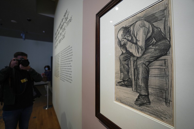 A photographer takes pictures of Study for "Worn Out", a drawing by Dutch master Vincent van Gogh, dated Nov. 1882, on public display for the first time at the Van Gogh Museum in Amsterdam, Netherlands, Thursday, Sept. 16, 2021. (AP Photo/Peter Dejong)
