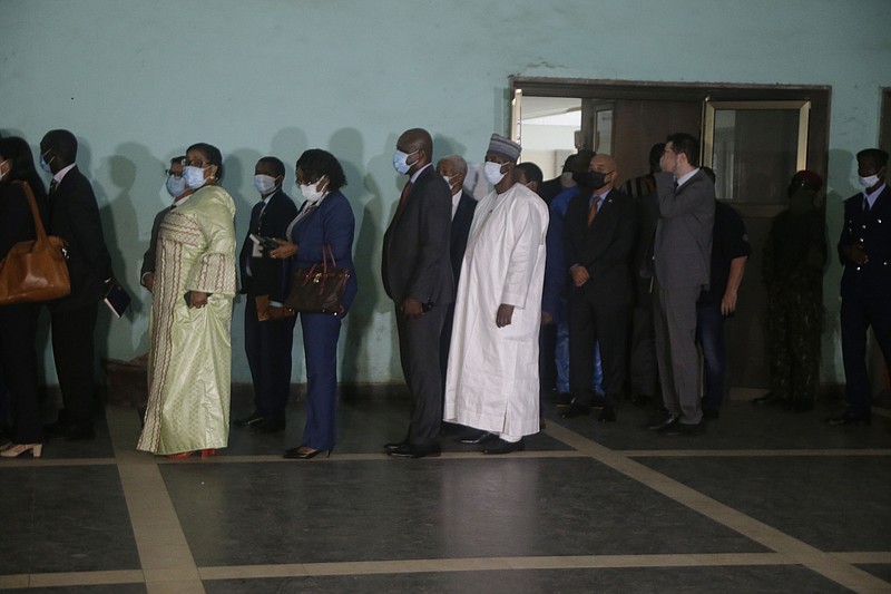 Ambassadors and foreign representations, wait for a meeting with Military junta led by Col. Mamady Doumbouya, at the people's palace in Conakry, Guinea Wednesday, Sept. 15, 2021. Guinea's junta is expected to face more pressure to set a timeframe for new elections Tuesday as the military rulers open a four-day series of meetings about the West African nation's future following the president's overthrow in a coup just over a week ago. (AP Photo/Sunday Alamba)