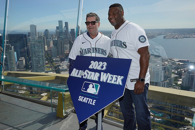 Seattle Mariners legends Edgar Martinez, left, and Ken Griffey Jr., right, pose for a photo before raising a flag for the 2023 MLB All-Star Game on the roof of the Space Needle, Thursday, Sept. 16, 2021, in Seattle. Earlier in the day, MLB Commissioner Rob Manfred announced that the Mariners will host the game at T-Mobile Park. (AP Photo/Ted S. Warren)