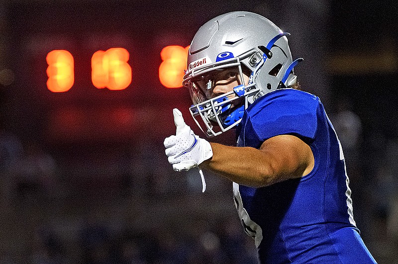 Capital City wide receiver Caleb Busch checks his alignment with an official as the Cavaliers try to move the ball down field during a matchup earlier this month against the Kansas City Center Yellowjackets at Adkins Stadium.