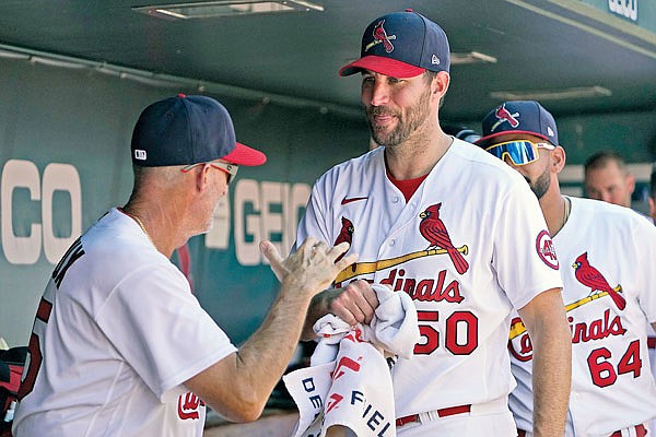 In this Aug. 22 file photo, Cardinals starting pitcher Adam Wainwright is congratulated by pitching coach Mike Maddux after being removed during the eighth inning of a game against the Pirates at Busch Stadium.