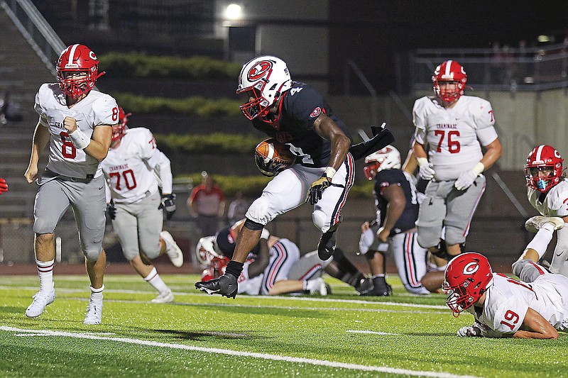 Jefferson City running back David Bethune jumps to avoid a defender during a game against Chaminade earlier this season at Adkins Stadium.