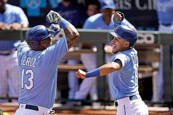 Royals teammates Salvador Perez and Nicky Lopez celebrate after Perez hit a two-run home run in the bottom of the first inning of Thursday afternoon's game against the Athletics at Kauffman Stadium.