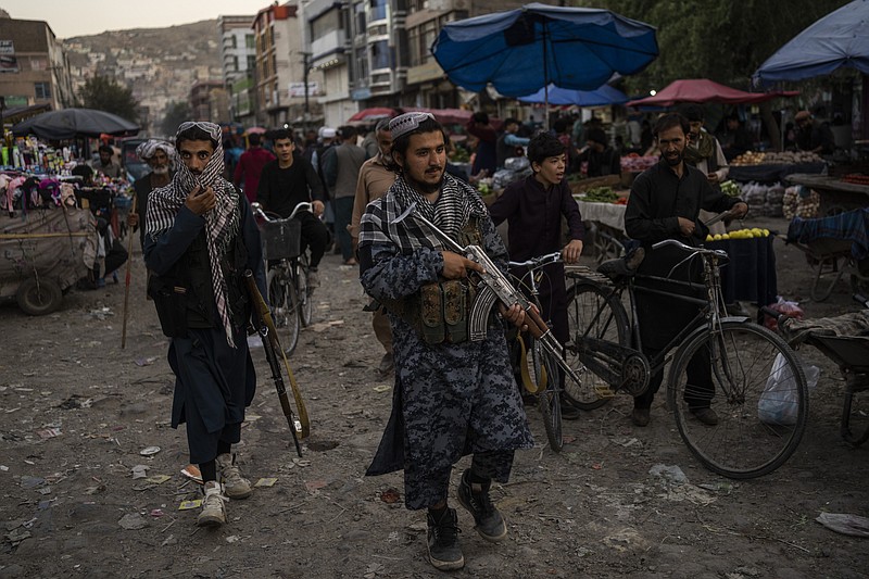 Taliban fighters patrol a market in Kabul's Old City, Afghanistan, Tuesday, Sept. 14, 2021. It is feared Afghanistan could further plunge toward famine and economic collapse after the chaos of the past month, which saw the Taliban oust the government in a lightning sweep as U.S. and NATO forces exited the 20-year war. (AP Photo/Bernat Armangue)