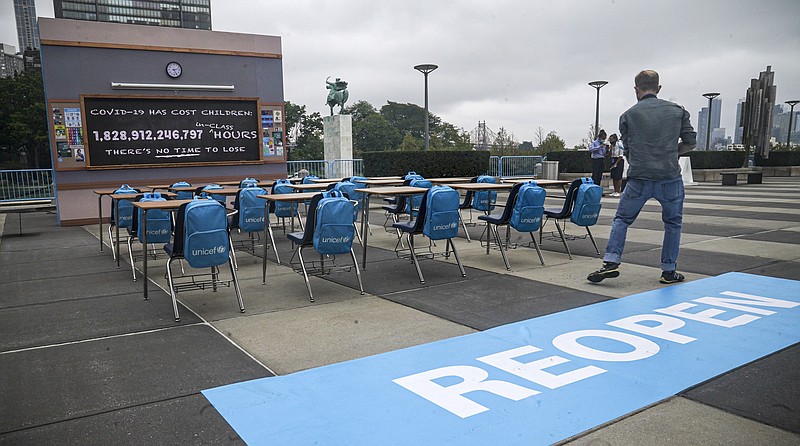 UNICEF unveiled its art installation 'No Time to Lose,' featuring a counting clock on a blackboard of an empty classroom, displaying in real-time the 1.8 trillion hours – and counting – of lost in-person learning around the world since the pandemic's onset, Friday Sept. 17, 2021 at U.N. headquarters. The installation will be on display throughout the course of the 76th session of the United Nations General Assembly (UNGA). (AP Photo/Bebeto Matthews)