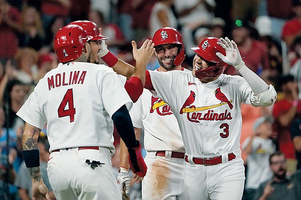 Dylan Carlson is congratulated by Cardinals teammates Yadier Molina (4), Paul Goldschmidt (second from right) and Nolan Arenado after hitting a grand slam during the eighth inning of Friday night's game agianst the Padres at Busch Stadium.