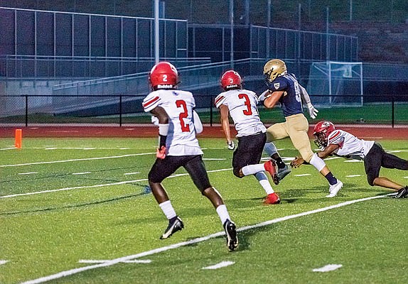 Sam Schell of Helias runs down the field after making a catch during Friday night's game against Granite City at Ray Hentges Stadium.