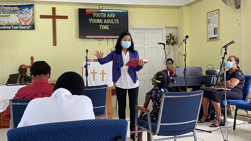 In this 2021 photo provided by Global Ministries, Global Mission Fellow Wingamkamliu Rentta leads youth and young adults in St. Lucia, during her service with the Methodist Church in the Caribbean and the Americas. Faith groups are taking various approaches to COVID-19 vaccines for missionaries. The United Methodist Church encourages but does not mandate its missionaries get the COVID-19 vaccine. The Southern Baptist Convention's International Mission Board does require it. (Global Ministries via AP)