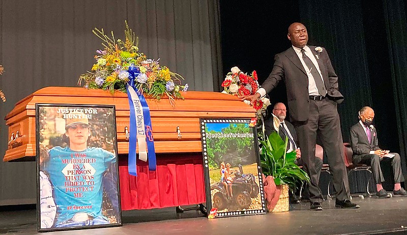 Attorney Ben Crump stands next to Hunter Brittain's casket at the Beebe High School Auditorium before his memorial service in Beebe, Ark., on Tuesday, July 6, 2021. Brittain was shot and killed by a Lonoke County Sheriff's deputy during a traffic stop June 23. (AP Photo/Andrew Demillo, File)