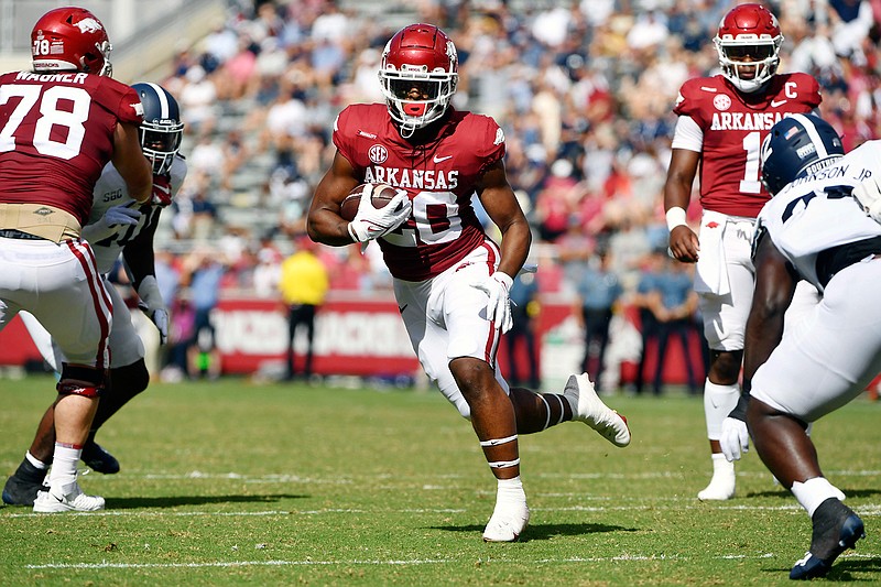 Arkansas running back Dominique Johnson (20) finds a hole in the Georgia Southern defense as he runs for a touchdown during the first half of an NCAA college football game Saturday, Sept. 18, 2021, in Fayetteville, Ark. (AP Photo/Michael Woods)