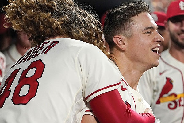 Tyler O'Neill of the Cardinals (right) is congratulated by teammate Harrison Bader after hitting a two-run home run during the eighth inning of Saturday night's game against the Padres at Busch Stadium.
