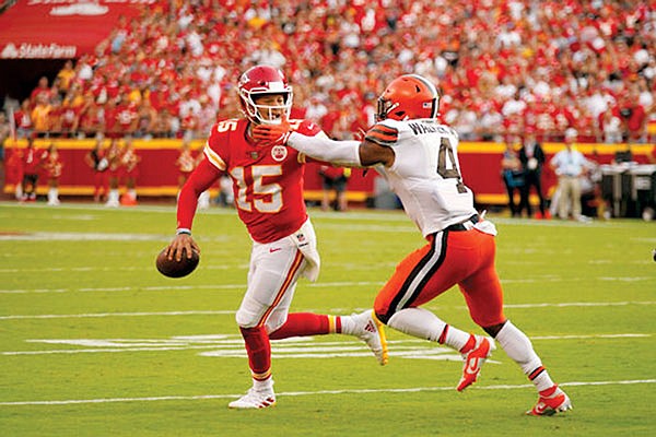 Chiefs quarterback Patrick Mahomes scrambles away from Browns linebacker Anthony Walker Jr. during last Sunday's game at Arrowhead Stadium.