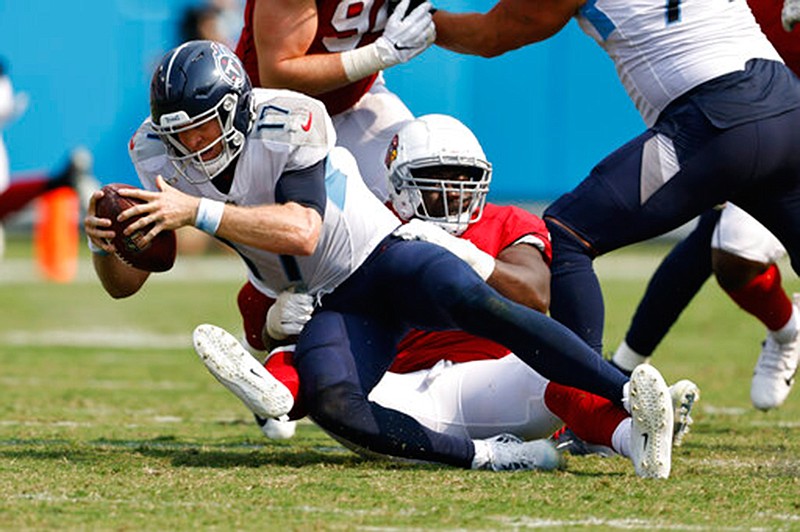 Tennessee Titans quarterback Ryan Tannehill (17) is sacked by Arizona Cardinals defensive end Michael Dogbe in the second half of an NFL football game Sunday, Sept. 12, 2021, in Nashville, Tenn. (AP Photo/Wade Payne)