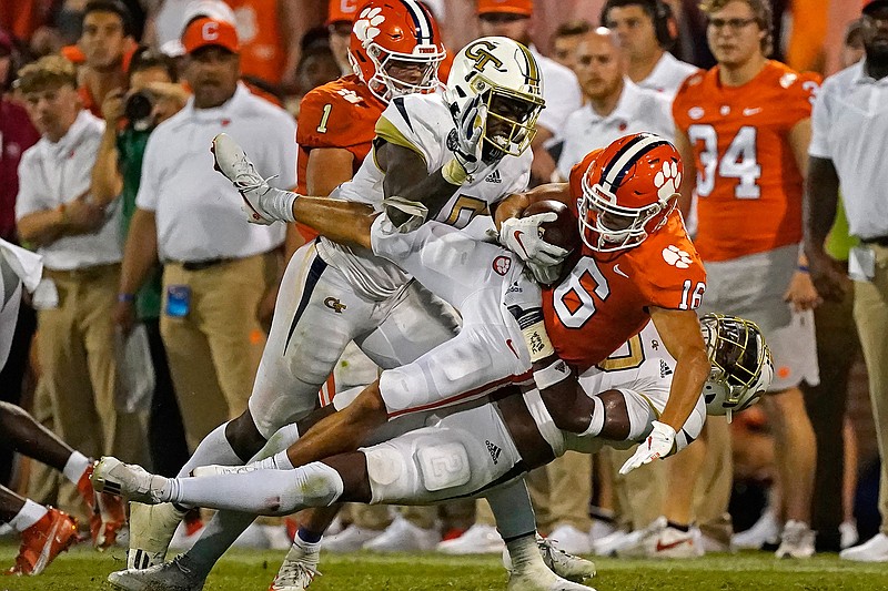 Clemson wide receiver E.J. Williams (6) is brought down by Georgia Tech' Ayinde Eley (10) and Tariq Carpenter (2) after a catch in the second half of an NCAA college football game, Saturday, Sept. 18, 2021, in Clemson, S.C. (AP Photo/John Bazemore)