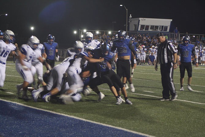 A mass of bodies from South Callaway and Montgomery County collide Friday night as the Bulldogs try to score their third touchdown near the end of the first half. They would be successful and would eventually win 41-28.