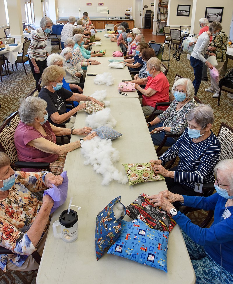 Julie Smith/News Tribune
Members of Sewing With a Cause worked Thursday afternoon to stuff small pillows that will be given to local non-profit organizations. Sewing With a Cause is a group of over two dozen volunteers who live at Heisinger Bluffs. Thursday saw the group and guest help stuff dozens of pillows as they try to reach the pre-Covid goal of approximately 500 pillows per year. The group will be recognized in St. Louis Monday with the LeadingAge Missouri Volunteer of the Year Award.