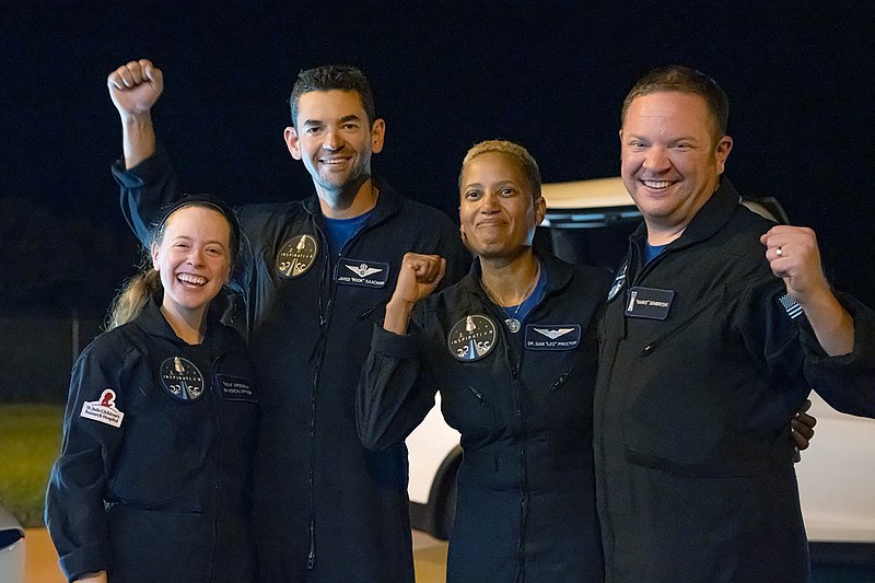 In this image released by Inspiration4, passengers aboard a SpaceX capsule, from left to right, Hayley Arceneaux, Jared Isaacman,  Sian Proctor and Chris Sembroski pose after the capsule was recovered following its splashdown in the Atlantic off the Florida coast, Saturday, Sept. 18, 2021. The all-amateur crew was the first to circle the world without a professional astronaut.  (John Kraus/Inspiration4 via AP)