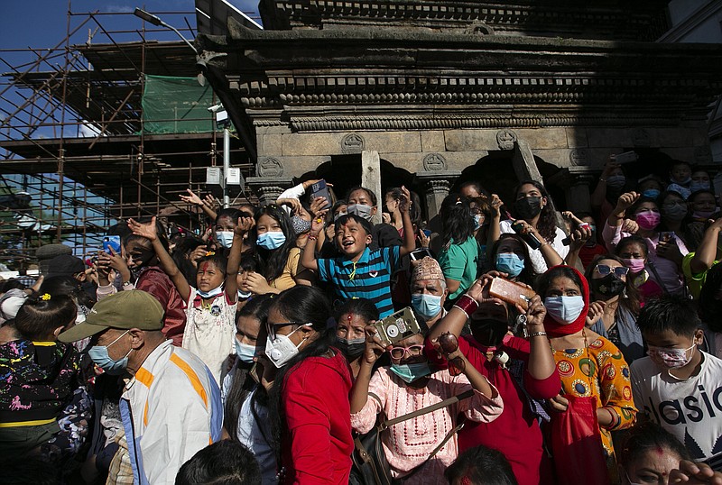 <p>Nepalese devotees gather to watch the annual Indra Jatra festival in Kathmandu, Nepal, Sunday, Sept. 19, 2021. The feast of Indra Jatra marks the return of the festival season in the Himalayan nation two years after it was scaled down because the pandemic. (AP Photo/Niranjan Shrestha)</p>