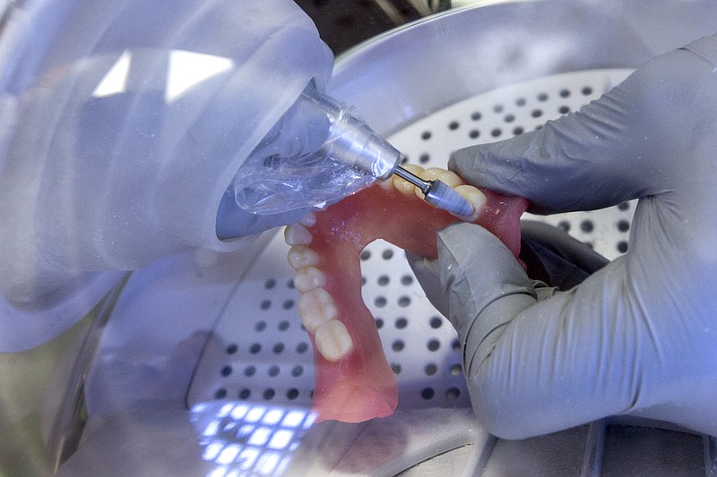 <p>In this June 13, 2019, file photo a dentist smooths out the edges of new 3D printed dentures in Huntsville, Texas. Dental work for Medicare recipients. An end to sky’s-the-limit pricing on prescription drugs. Coverage for low-income people locked out of Medicaid because of political battles. Those are just some of the changes to health care that Democrats want to achieve with President Joe Biden’s massive “Build Back Better” plan. (Brett Coomer/Houston Chronicle via AP, File)</p>