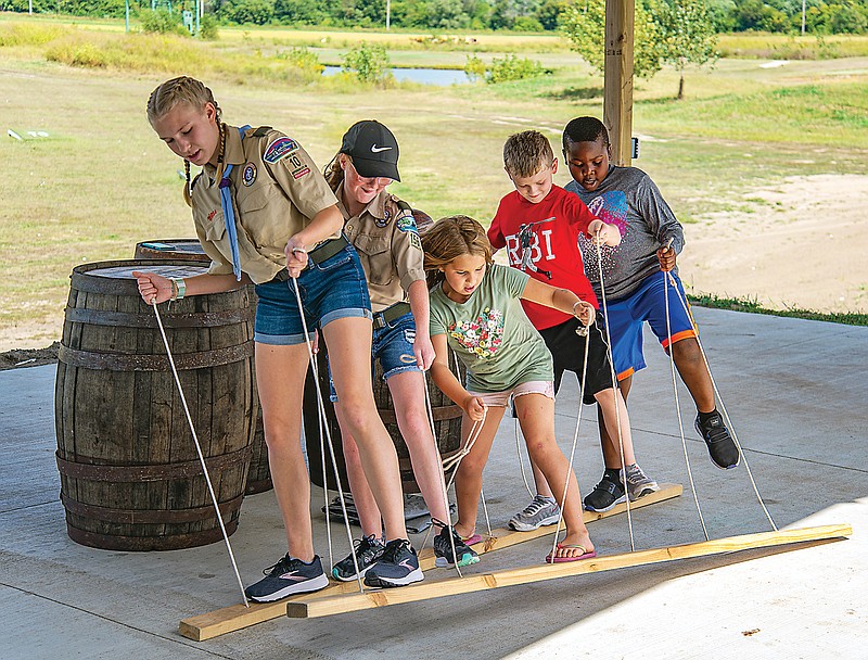 <p>Ken Barnes/News Tribune</p><p>A Scout from Grace Episcopal Church’s Scouts BSA Girls Troop 10 leads a ski walking activity Sunday at the BSA Family Field Day at Capital Bluffs.</p>