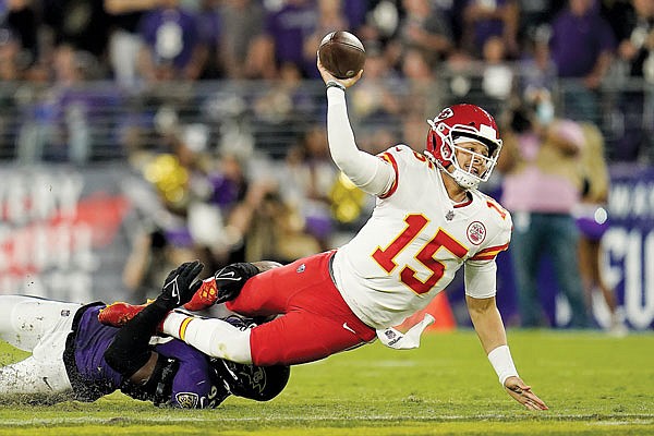 Chiefs quarterback Patrick Mahomes makes a pass attempt as he is tackled by Ravens linebacker Odafe Oweh in the second half of Sunday night's game in Baltimore. 