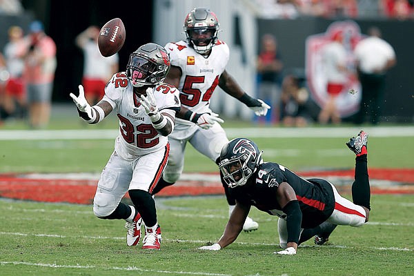 Buccaneers safety Mike Edwards intercepts a pass intended for Falcons wide receiver Russell Gage and returns it for a touchdown during the second half of Sunday's game in Tampa, Fla.