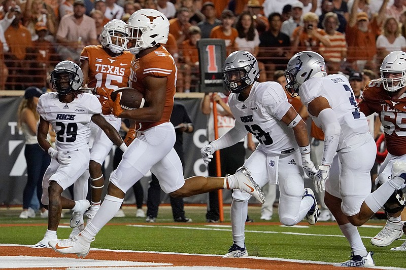 Texas running back Bijan Robinson (5) runs for a touchdown against Rice during the first half of an NCAA college football game Saturday, Sept. 18, 2021, in Austin, Texas. (AP Photo/Chuck Burton)