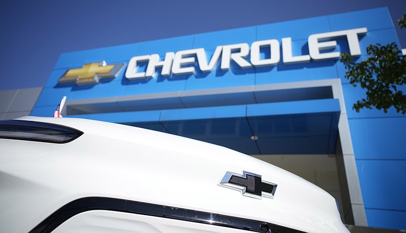 The company logo shines off the nose of an unsold 2022 Bolt electric vehicle on display in front of a Chevrolet dealership Sunday, Sept. 12, 2021, in Englewood, Colo. General Motors said Monday, Sept. 20, 2021 that production has resumed for battery modules used in recalled Chevrolet Bolt electric vehicles, and customers could start getting replacement parts by mid-October. (AP Photo/David Zalubowski)