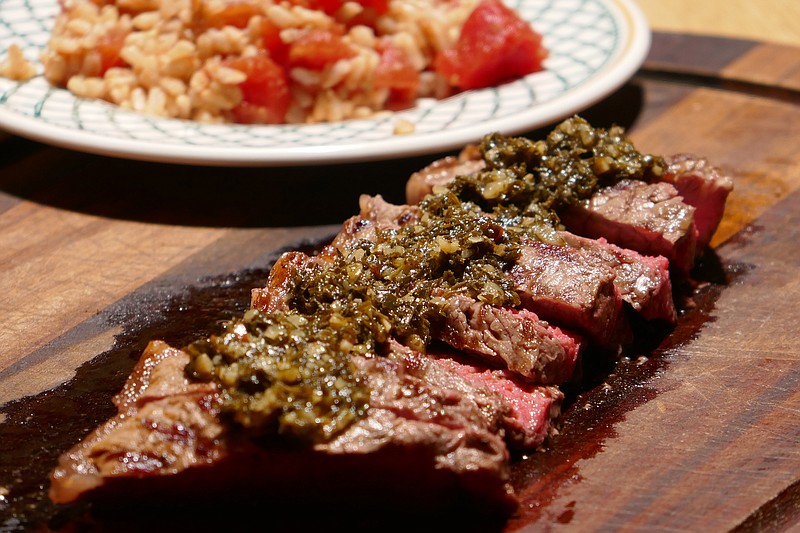 Churrasco Steak with Chimichurri Sauce and Rice and Tomatoes. (Linda Gassenheimer/TNS)