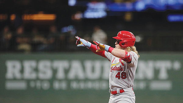 Harrison Bader gestures to the Cardinals dugout after hitting a double during the second inning of Tuesday night's game against the Brewers in Milwaukee.