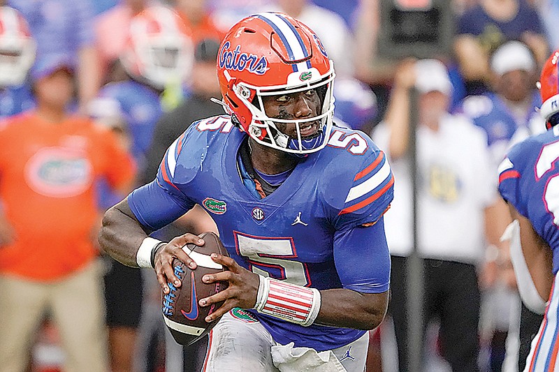 Florida quarterback Emory Jones scrambles as he looks for a receiver against Alabama during the second half of an NCAA college football game, Saturday, Sept. 18, 2021, in Gainesville, Fla. (AP Photo/John Raoux)