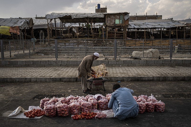 An Afghan man sells fruit on a street in Kabul, Afghanistan, Wednesday, Sept. 22, 2021. (AP Photo/Bernat Armangue)