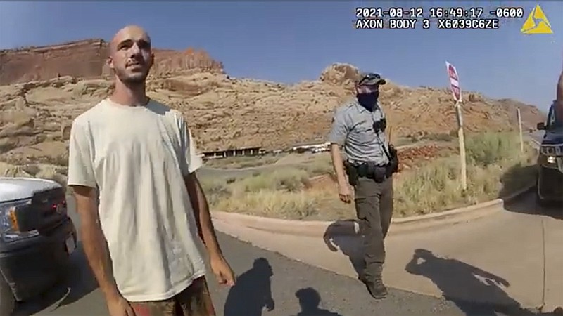 FILE - This Aug. 12, 2021 file photo from video provided by The Moab Police Department shows Brian Laundrie talking to a police officer after police pulled over the van he was traveling in with his girlfriend, Gabrielle "Gabby" Petito, near the entrance to Arches National Park. Laundrie, the boyfriend of Gabby Petito, whose body was found at a national park in Wyoming after a cross-country trip with him, has been charged with unauthorized use of a debit card as searchers continue looking for him in Florida swampland, federal authorities announced Thursday, Sept. 23, 2021. (The Moab Police Department via AP, File)