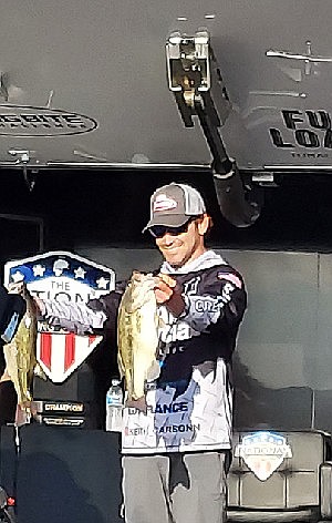 Keith Carson displays a pair of his winning fish on day three of the National Professional Fishing League tournament held at Wright Patman Lake, April 24 in Texarkana, Texas. Carson led each day and finished with a total of 67 pounds, 10 ounces to claim the $50,000 grand prize.