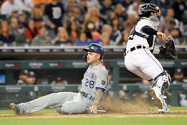 Kyle Isbel of the Royals slides home safely pastTigers catcher Eric Haase on a sacrifice fly by Whit Merrifield in the eighth inning of Friday night's gae in Detroit.