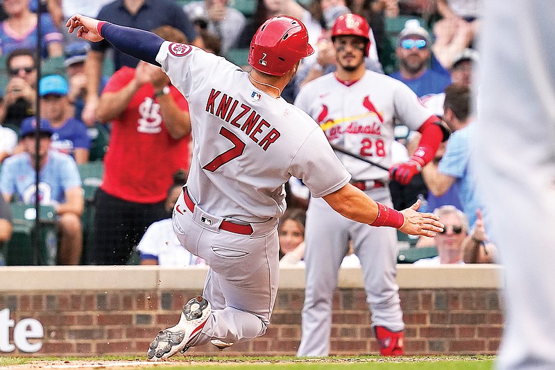 Andrew Knizner of the Cardinals scores on a wild pitch by Cubs relief pitcher Codi Heuer during the ninth inning of Sunday afternoon's game at Wrigley Field in Chicago.