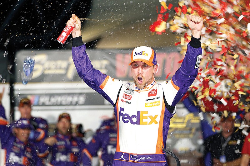 Denny Hamlin celebrates in victory lane Sunday after winning a NASCAR Cup Series race at Las Vegas Motor Speedway in Las Vegas.