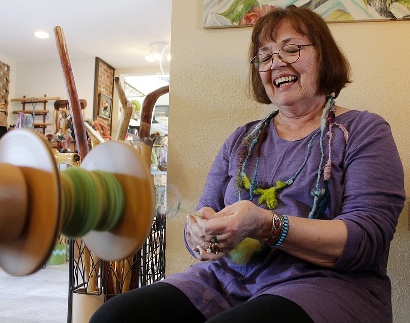 <p>News Tribune file</p><p>Gail Barnickol spins wool to demonstrate the process at The Art Bazaar during a past Art Around Town Gallery Crawl. The event returns to the Capital City on Oct. 7.</p>