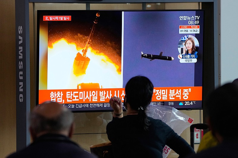 People watch a TV showing a file image of North Korea's missiles launch during a news program at the Seoul Railway Station in Seoul, South Korea, Tuesday, Sept. 28, 2021. North Korea on Tuesday fired a suspected ballistic missile into the sea, Seoul and Tokyo officials said, the latest in a series of weapons tests by Pyongyang that raised questions about the sincerity of its recent offer for talks with South Korea. The Korean letters read: "Ballistic missile." (AP Photo/Ahn Young-joon)