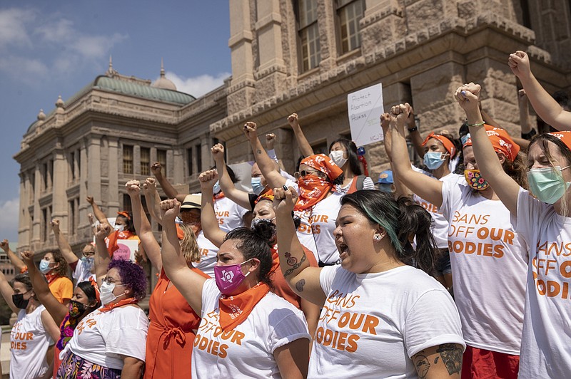 In this Sept. 1, 2021, file photo, women protest against the six-week abortion ban at the Capitol in Austin, Texas. A San Antonio doctor who said he performed an abortion in defiance of a new Texas law has all but dared supporters of the state's near-total ban on the procedure to try making an early example of him by filing a lawsuit. The state's largest anti-abortion group said Monday Sept. 20, 2021, that it is looking into the matter. (Jay Janner/Austin American-Statesman via AP, File)